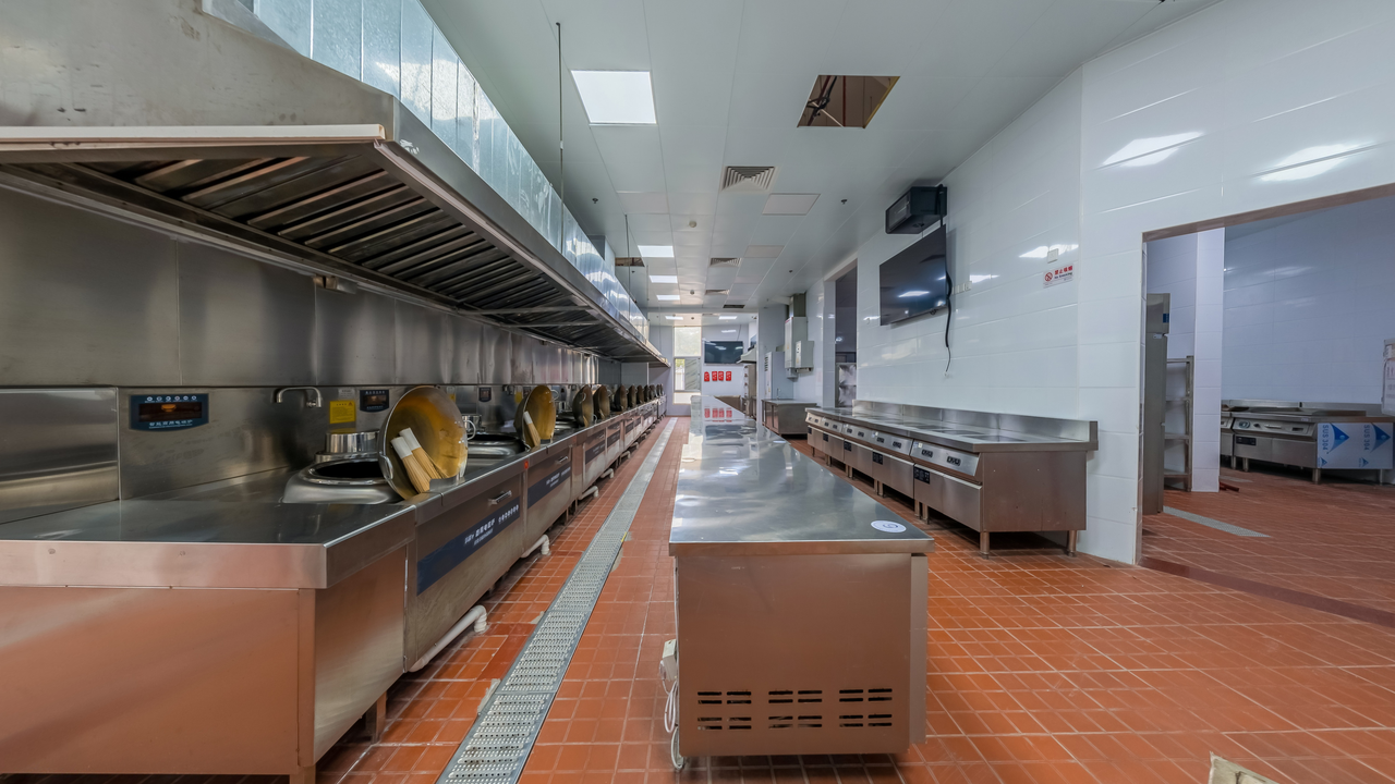 The Art of Drawing Readers In: Your attractive post title goes here Modern industrial kitchen interior featuring stainless steel appliances and tiled flooring, ideal for commercial use.